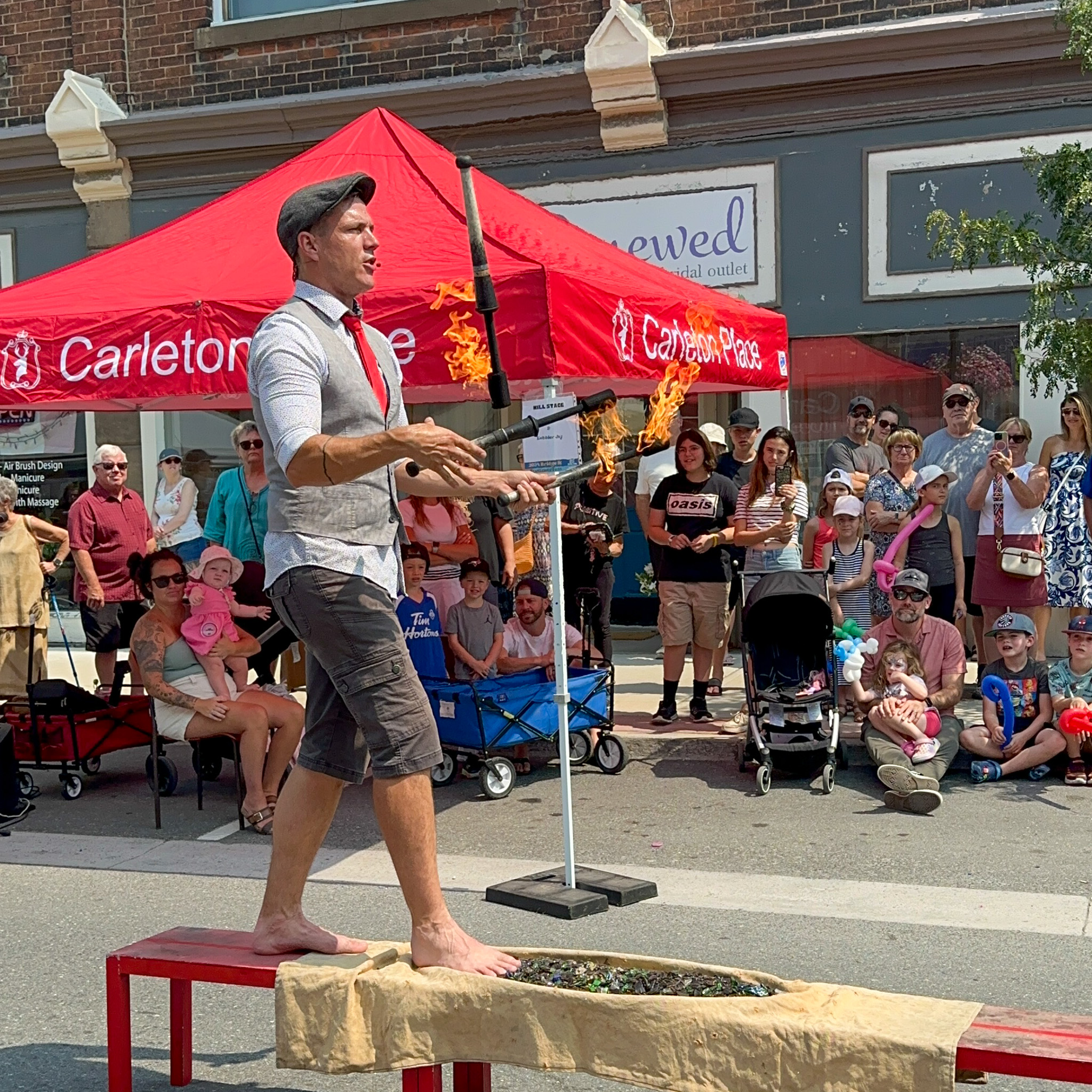 Kobbler Jay Juggling fire on broken glass at Summerfest