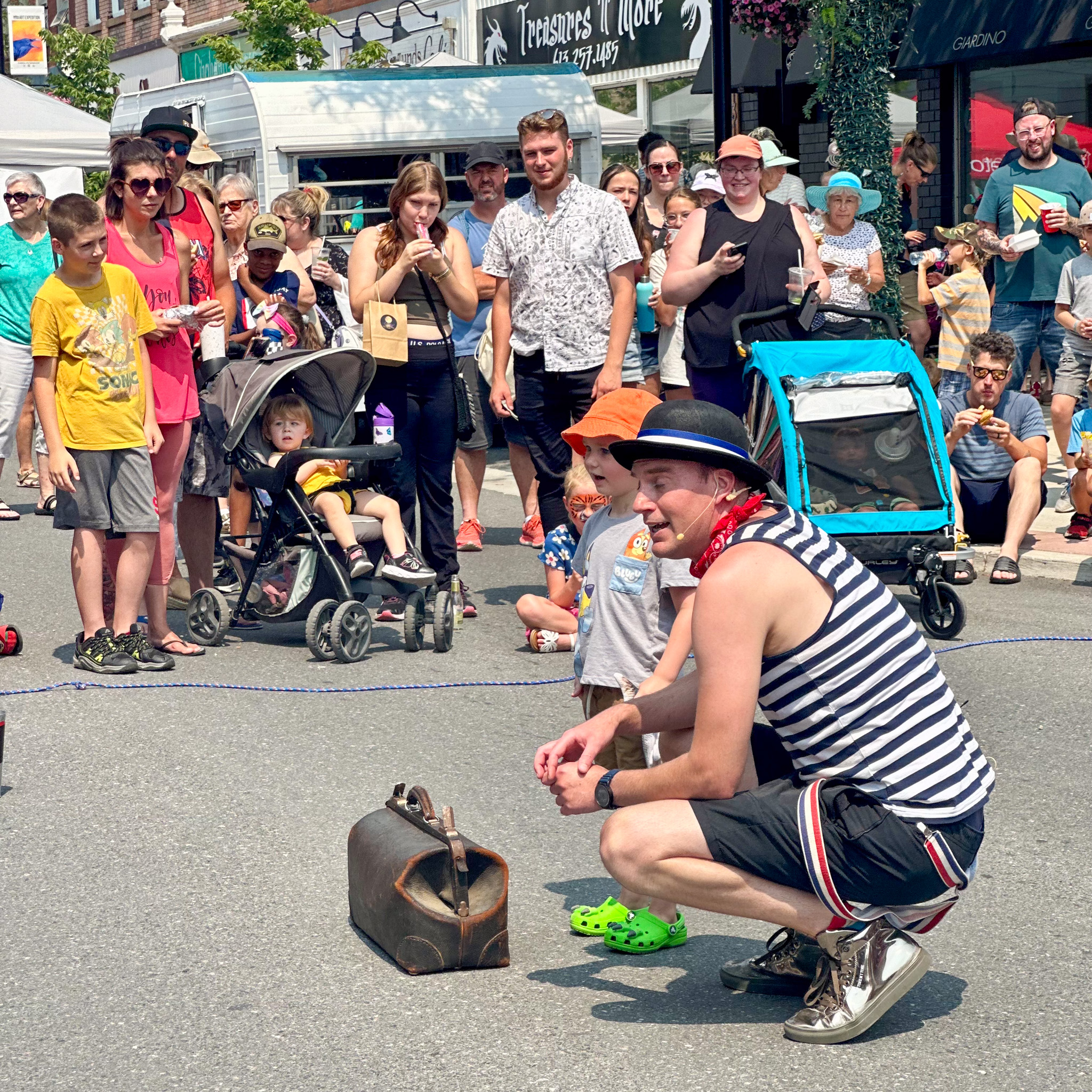 The Lucky Barber performing with a young helper at Summerfest