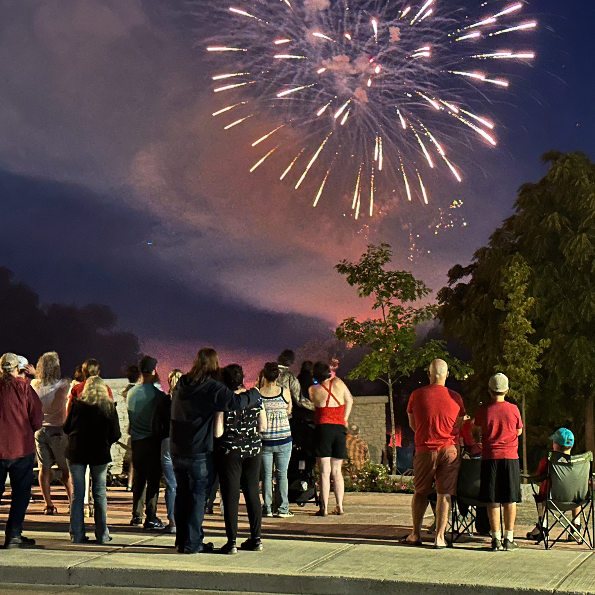 a crowd gathers to watch Canada Day Fireworks as seen from Central Bridge